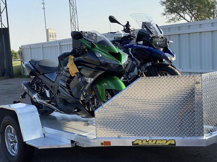 Motorcycles loaded onto an Aluma trailer.