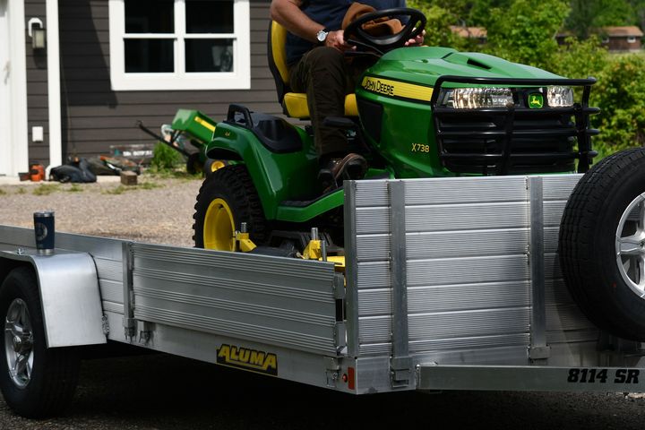 A John Deere tractor driven onto an Aluma trailer.