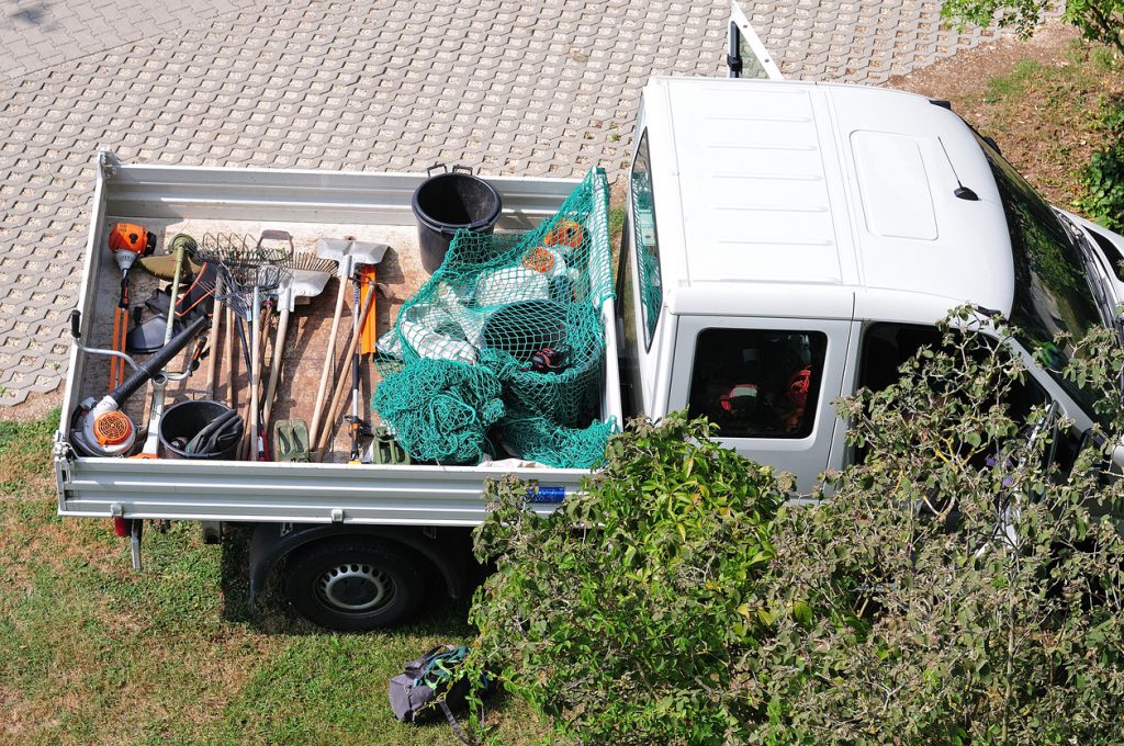 service body truck bed pickup of a gardening team with tools on loading area