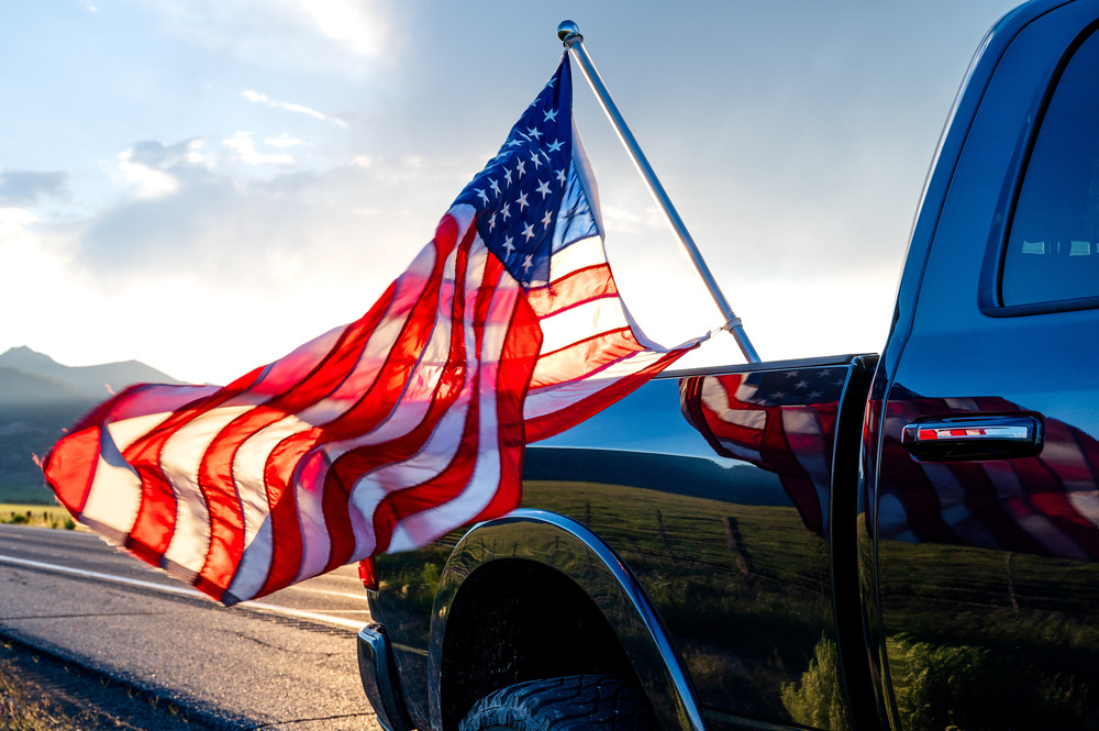 A flag flies in the bed of one of our best pickup trucks.