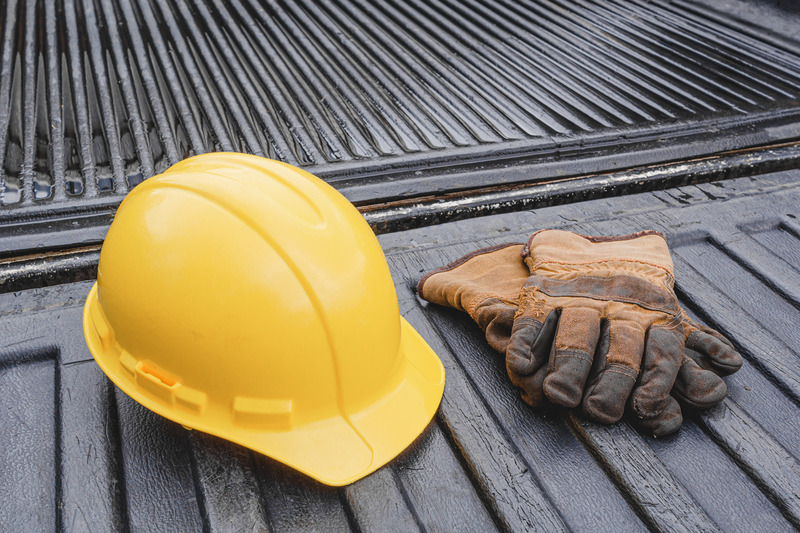 Hard hat and gloves in the bed of a pickup truck. 