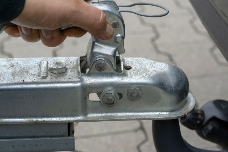 Person connecting a bumper pull hitch. 