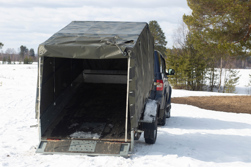 Cargo Trailer with the back ramp door open in the snow.