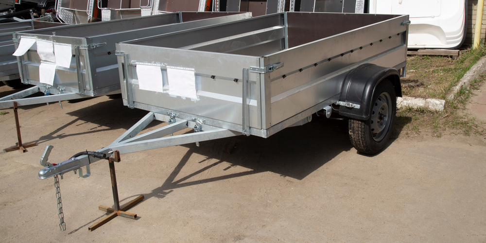 Rent to own trailers lined up at at dealership.