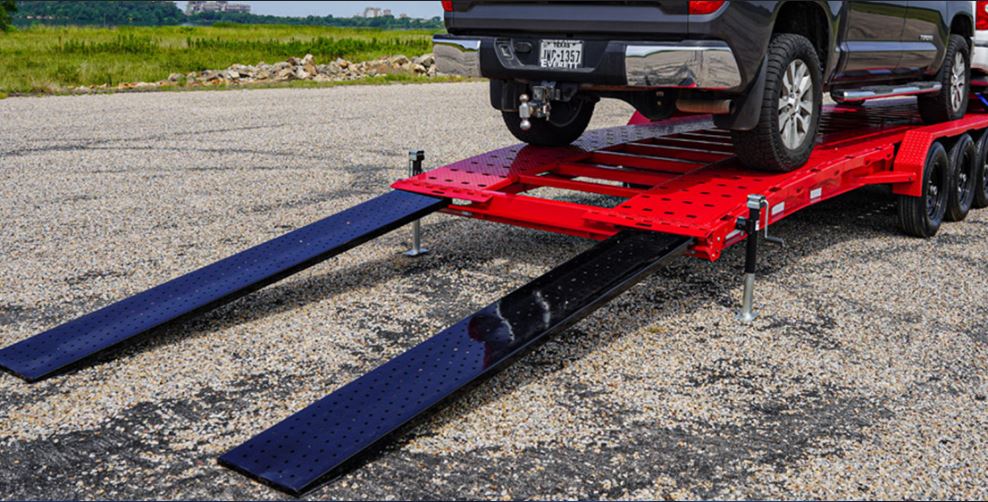 Cars loaded on a trailer. Closeup on loading ramps. 