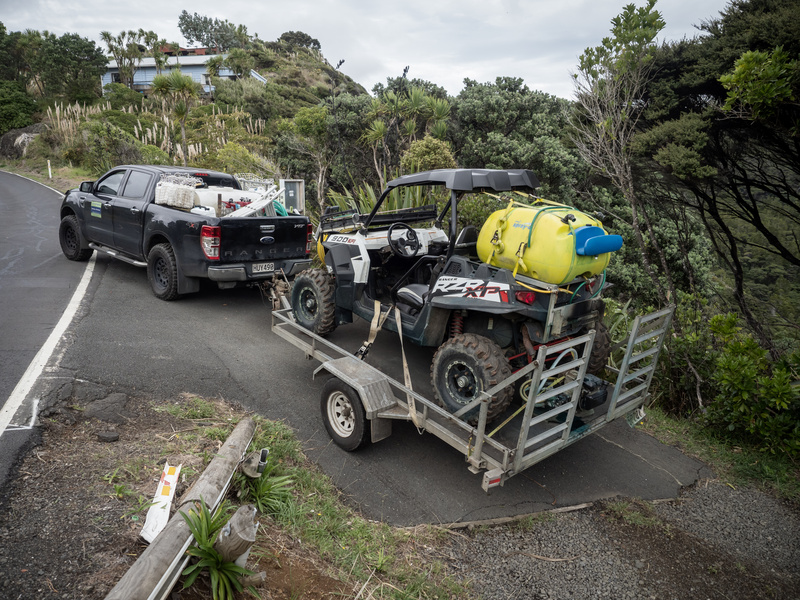 Truck hitched to a trailer with an ATV in the back. 