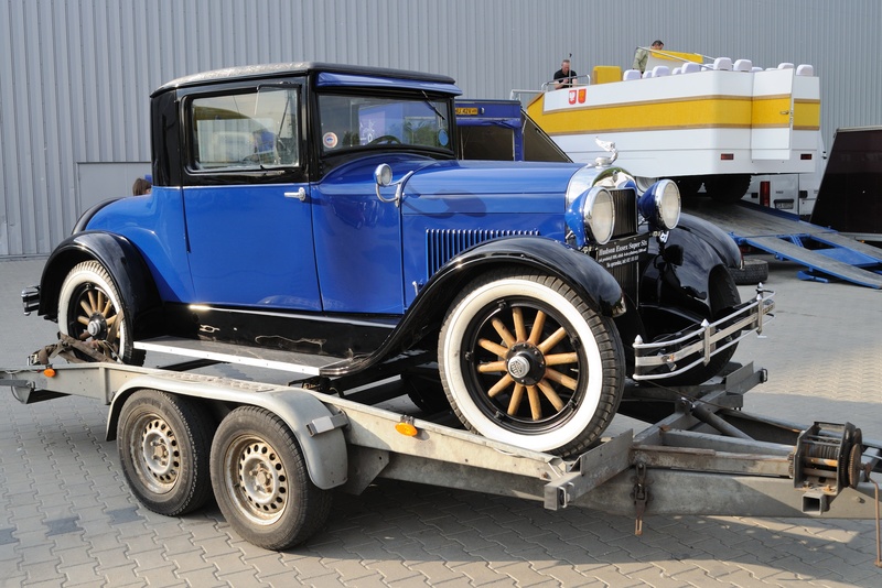 Antique car on a trailer in need of trailer maintenance. 