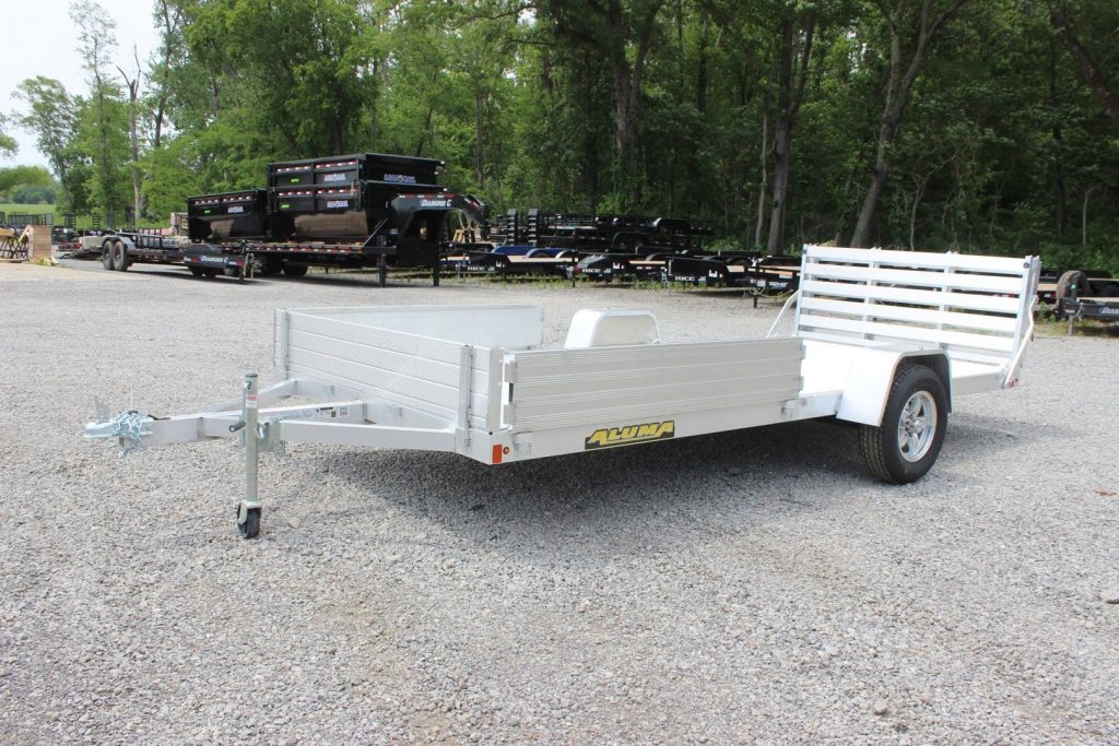 An Aluma Trailers utility trailer on the Country Blacksmith dealership lot.