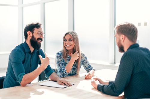 Couple discussing an offer on their trailer with a sales representative. 