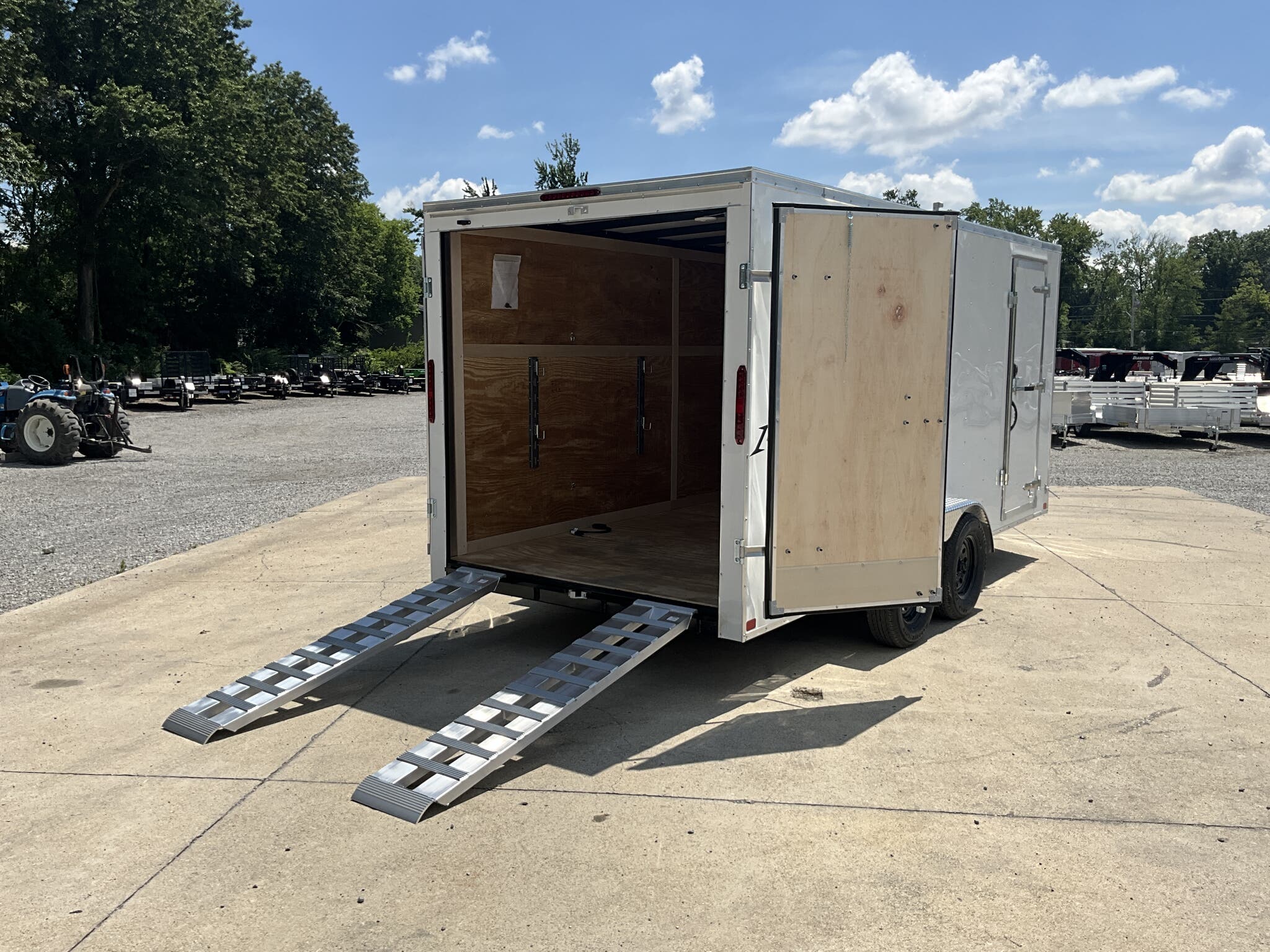 Homesteader enclosed trailer with rear double doors and extended ramps. 