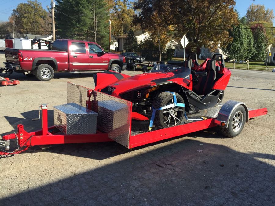 Red custom trailer with a polaris slingshot motercycle